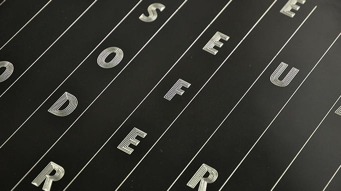 Engraving of multi-line fonts on signage plaques